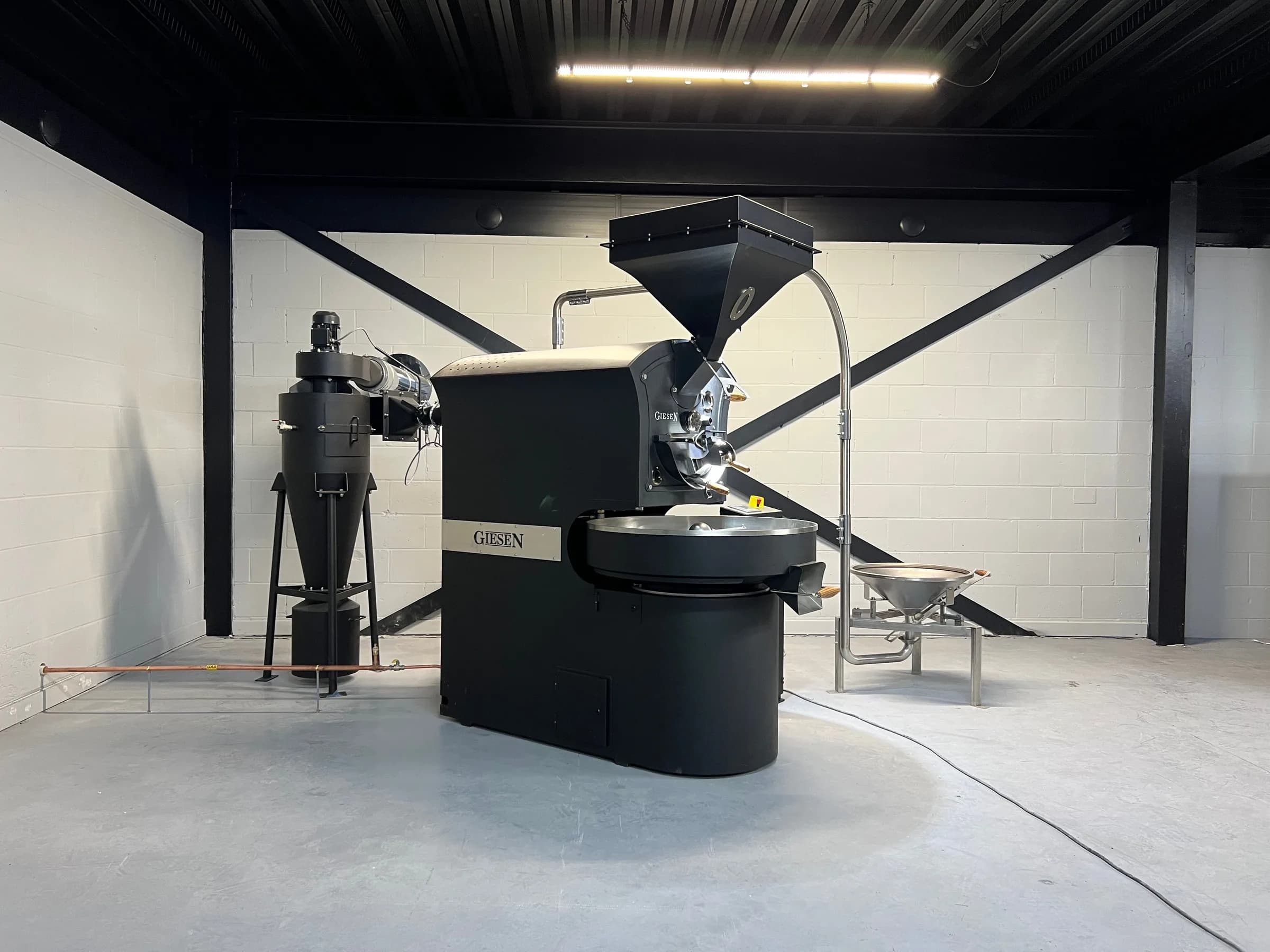 Giesen roaster installed in a bay with open floor and an afterburner alongside