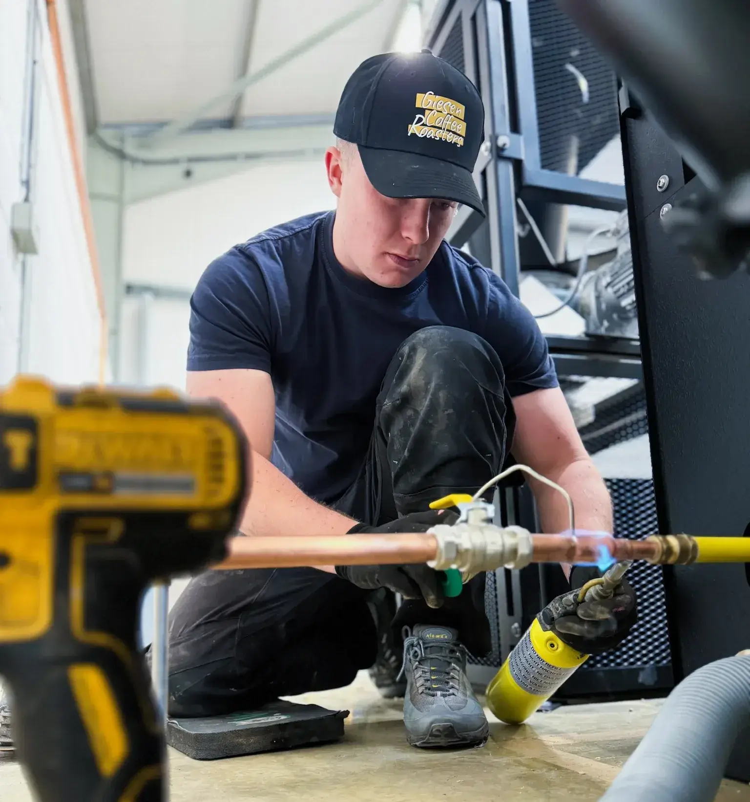 Engineer connecting services during a roaster installation